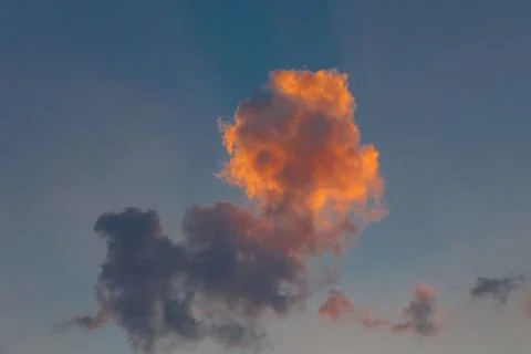 Fluffy red cloud against the sky. Sunset Stock Photos