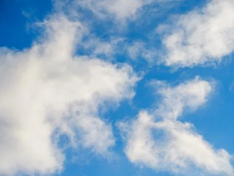 Fluffy soft clouds against a blue sky Stock Photos