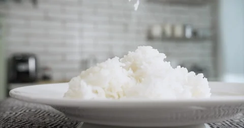 Fluffy steaming freshly cooked jasmine rice white plate using wooden rice ladle 動画素材 204835908