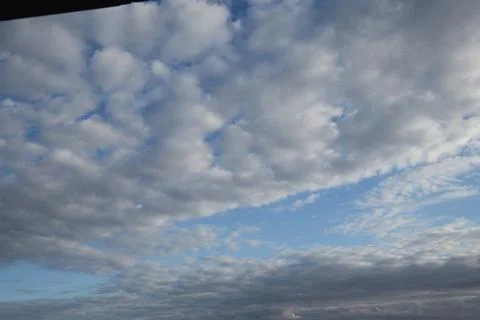 Fluffy white and gray clouds on blue sky background. Copy space Stock Photos