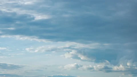 Fluffy white and grey clouds moving fast in time-lapse. Idyllic cloudy heaven Stock Footage 136200254