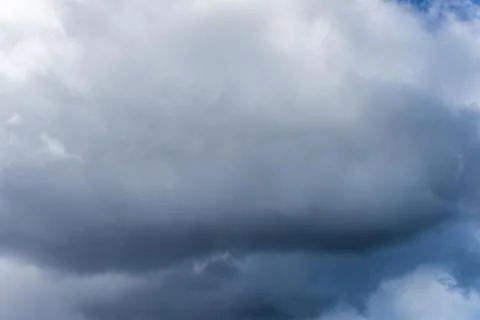 Fluffy white and grey clouds filling the frame 写真素材