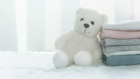 Fluffy white bear doll with soft comfortable pink grey blue fabric cloth stac Stock Photos