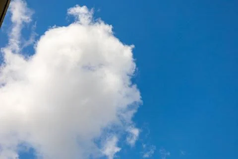 Fluffy White Cloud Against Clear Blue Sky Stock Photos