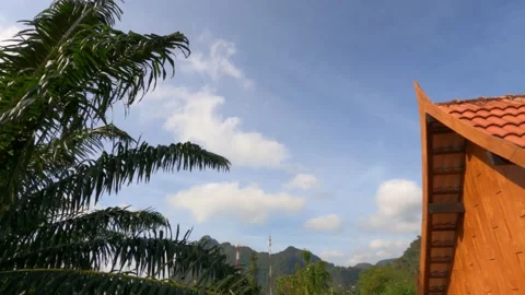 Fluffy white cloud blue sky over tradition wooden Thai house style roof top Stock Footage 147590731
