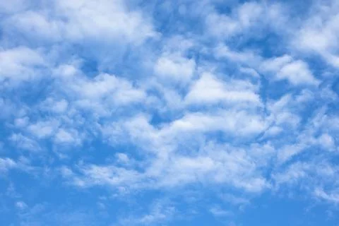 Fluffy White Clouds Against a Blue Sky Stock Photos