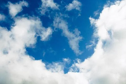 Fluffy White Clouds Against A Deep Blue Sky On A Bright Sunny Day Stock Photos