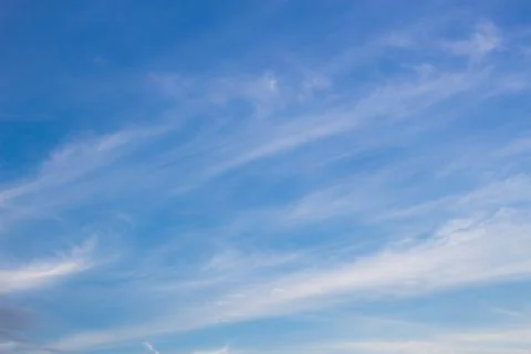 Fluffy white clouds and bright blue sky. Stock Photos