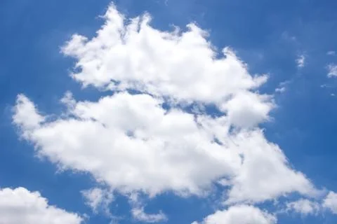 Fluffy white clouds and bright blue sky. Stock Photos