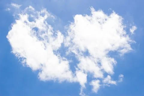 Fluffy white clouds and bright blue sky. Stock Photos