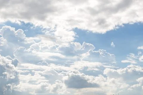 Fluffy white clouds and bright blue sky. Stock Photos