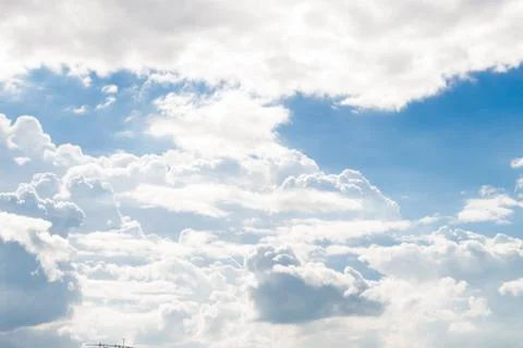 Fluffy white clouds and bright blue sky. Stock Photos