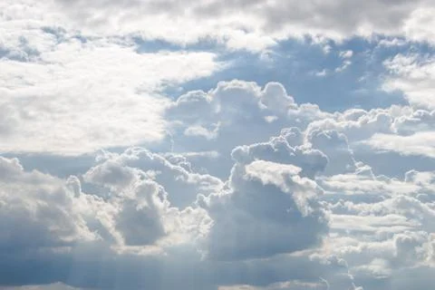 Fluffy white clouds and bright blue sky. Stock Photos