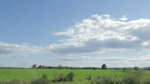 Fluffy White Clouds in Blue Sky Over Country Field Stock Footage 21455907