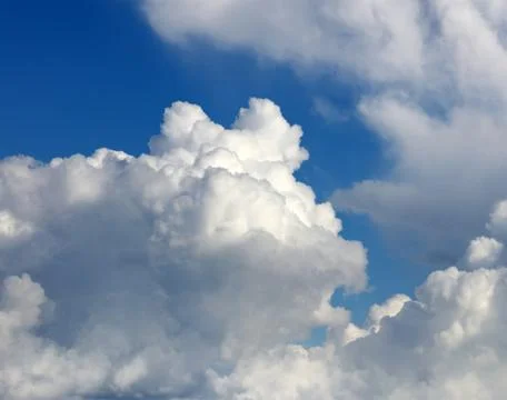 Fluffy white clouds in a blue sky Stock Photos