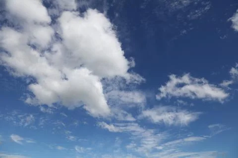 Fluffy white clouds in a blue sky Stock Photos