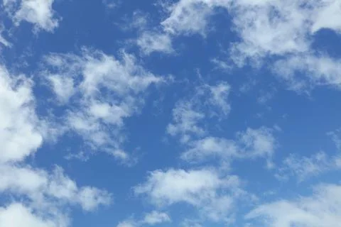 Fluffy white clouds in a blue sky Stock Photos