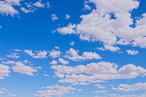 Fluffy white clouds in a blue sky. Stock Photos