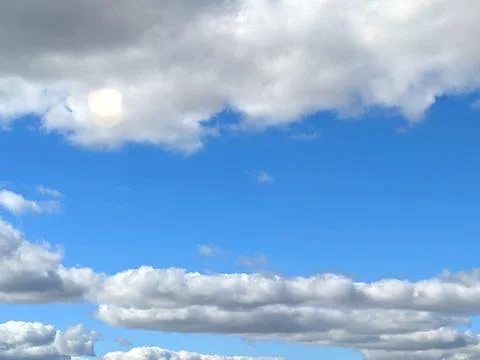 Fluffy White Clouds in a Blue Sky as A Skyscape Background Stock Photos