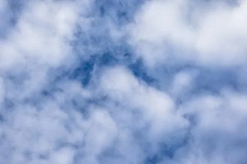 Fluffy White Clouds in a Blue Sky Stock Photos