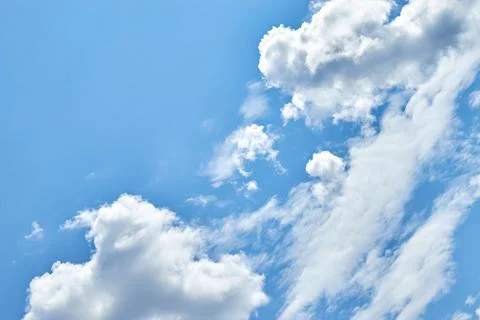 Fluffy white clouds in blue sky. Cumulus cloudscape texture. Sunny summer s.. Stock Photos