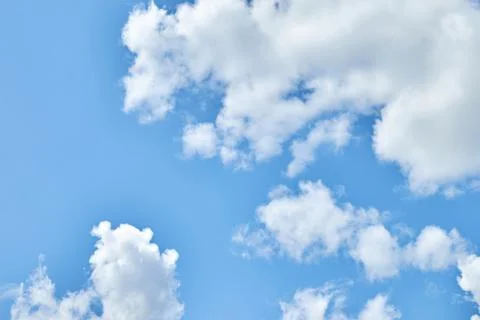 Fluffy white clouds in blue sky. Cumulus cloudscape texture. Sunny summer s.. Stock Photos