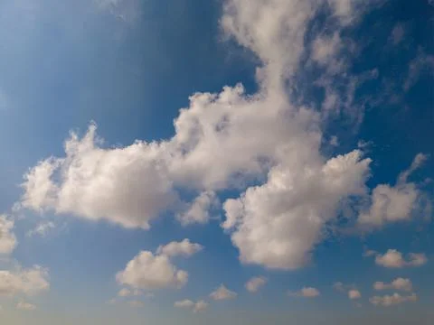 Fluffy White Clouds in a Bright Blue Sky on a Sunny Day Фото