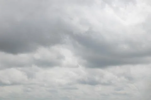 Fluffy white clouds covered the sun and sky during the day Stock Photos