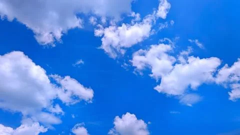 Fluffy White Clouds in Deep Blue Sky Stock Photos