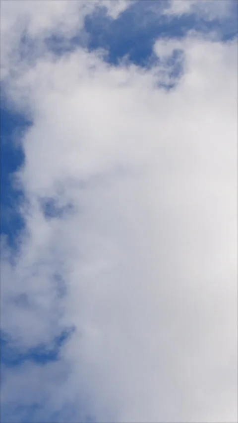 Fluffy White Clouds Drifting Across A Blue Sky. Vertical. 스톡 동영상 276179887