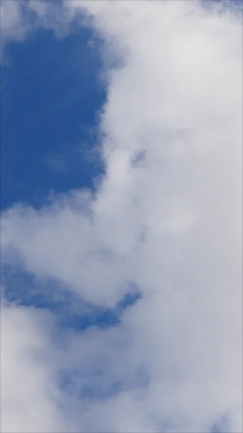 Fluffy White Clouds Drifting Across A Blue Sky. Vertical. Stock Footage 276495787