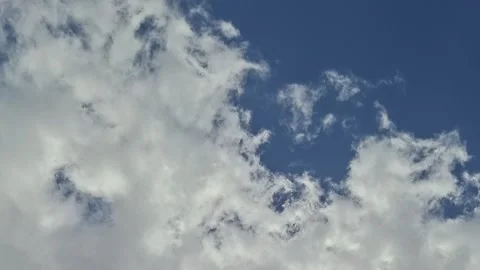 Fluffy White Clouds Drifting Across Blue Sky Stock Footage 331246254