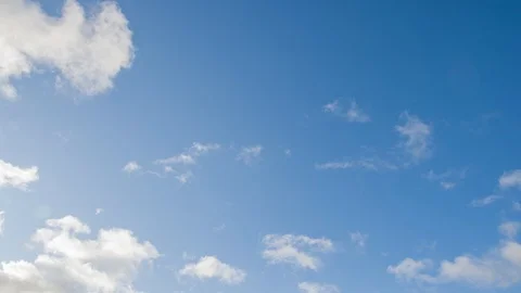 Fluffy White Clouds Float Across The Blue Sky Stock Footage 120612985