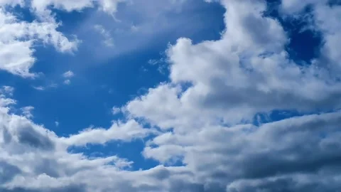 Fluffy White Clouds Moving Across Bright Blue Sky Stock Footage 316545496