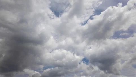 Fluffy white clouds moving across vibrant blue sky on sunny summer day Stock Footage 341410394
