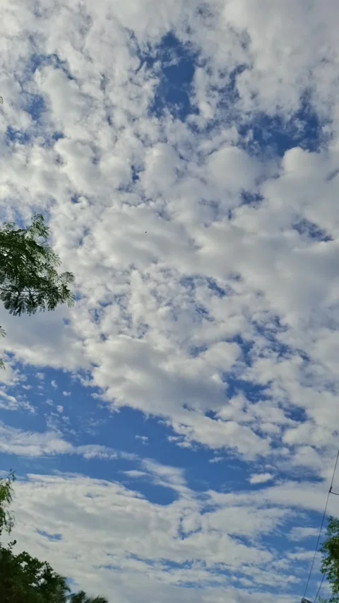 Fluffy white clouds moving in blue sky with natural daylight Video stock 337862194