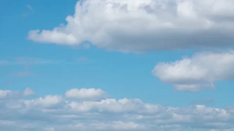 Fluffy white clouds moving in time-lapse. Daylight, cloudy heaven background Stock Footage 136491386