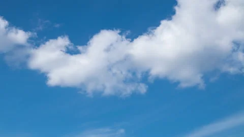 Fluffy white clouds moving in time-lapse. Daylight, cloudy heaven background Stock Footage 136700638