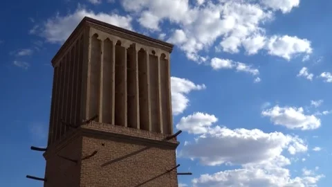 Of fluffy white clouds race across the brilliant blue sky, stock footage. Stock Footage 304829378