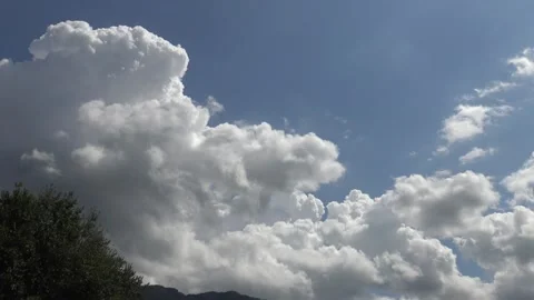 Fluffy white clouds rising on blue sky timelapse Stock Footage 159075750