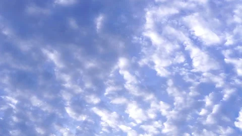 Fluffy white clouds scattering across vivid blue sky background Stock-Footage 340187454
