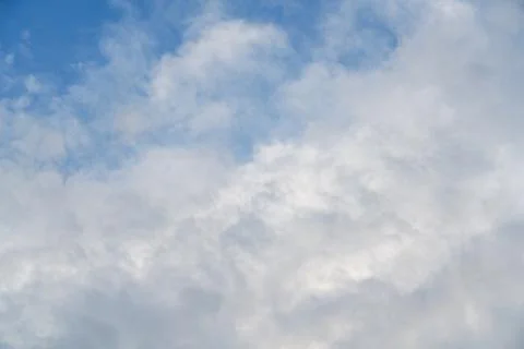 A fluffy white cumulus cloud in a pure blue sky Stock Photos