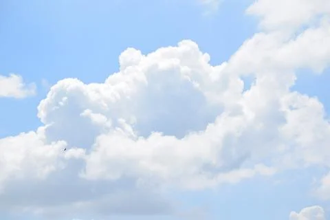 Fluffy White Cumulus Clouds in Bright Blue Summer Sky Stock Photos