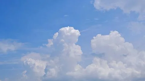 Fluffy White Cumulus Clouds in Clear Blue Sky Stock Photos