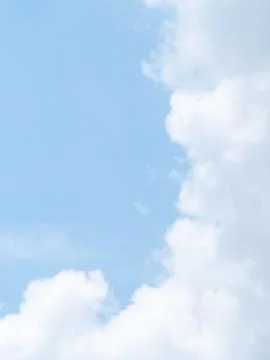 Fluffy White Cumulus Clouds Drifting Across Clear Blue Sky Background Stock Photos