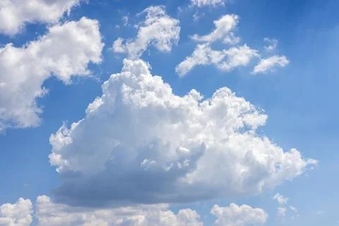 Fluffy white cumulus clouds floating in blue sky 写真素材