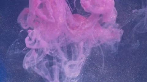 Fluid backdrop video with splashes pink color and glitter particles. A colorful Stock Footage 201807237