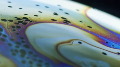 Fluid dynamics and light refraction diffraction in soap bubble surface Stock Footage 136340060