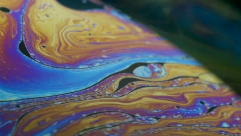 Fluid dynamics and light refraction diffraction in soap bubble surface Stock Footage 136340107