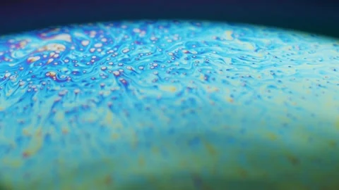 Fluid dynamics and light refraction diffraction in soap bubble surface Stock Footage 136340167